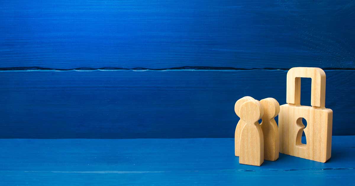 A wooden padlock with three wooden people in the same shape as the keyhole against a blue background